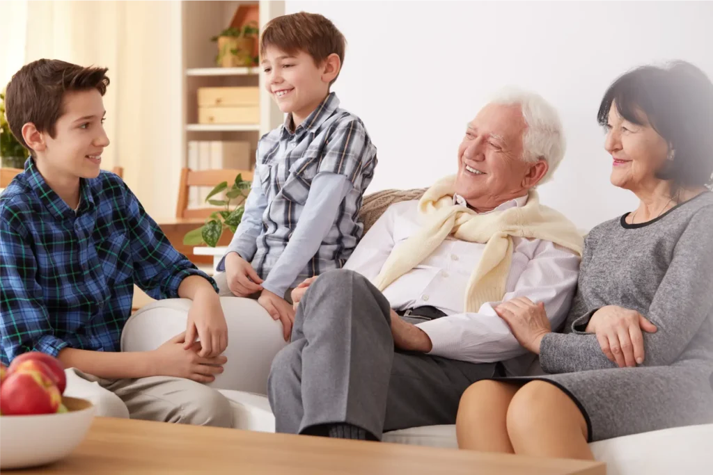 Family spending quality time with elderly parents at home supported by care in Sussex and Surrey