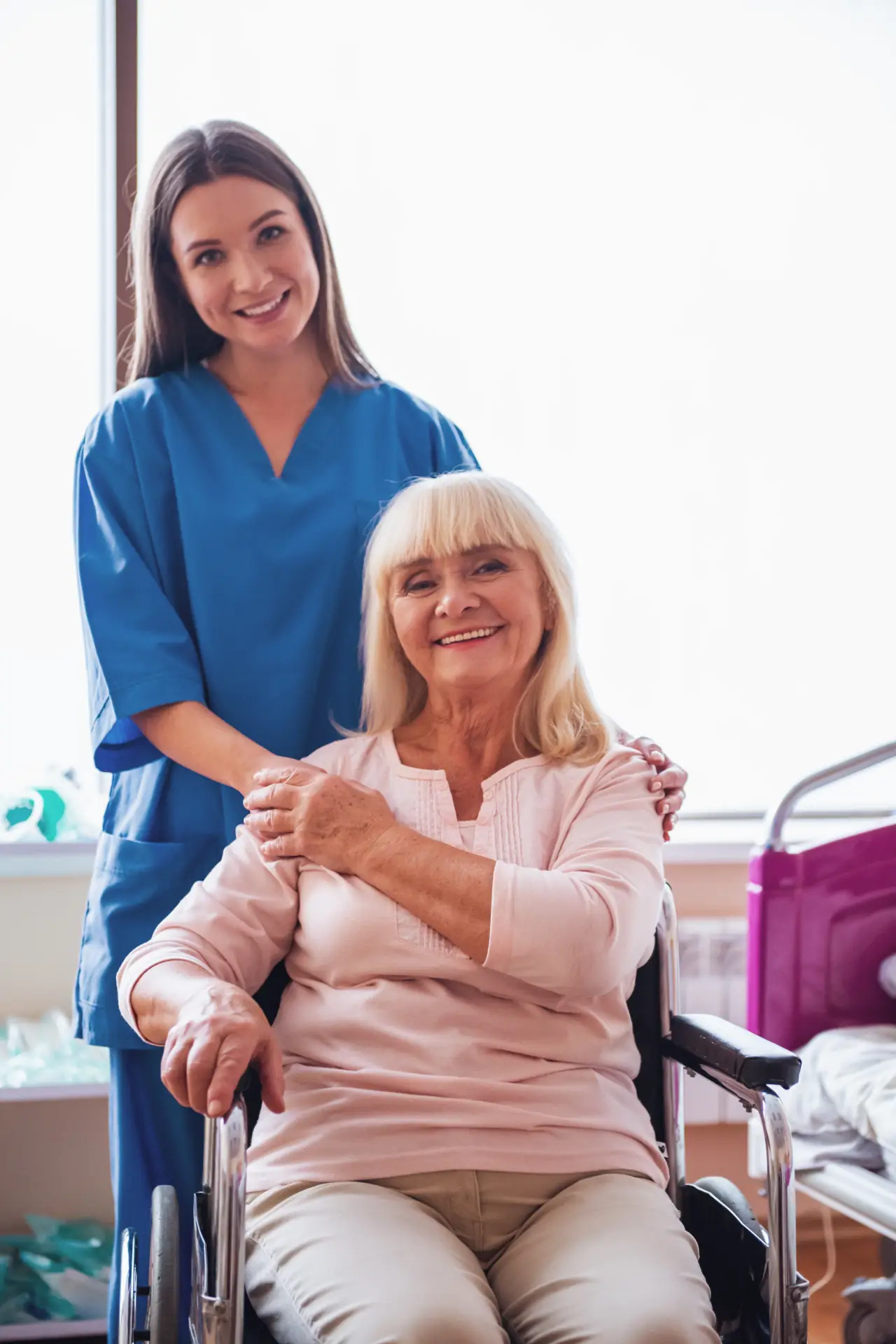 Caregiver supporting an older adult in a wheelchair with warmth and reassurance