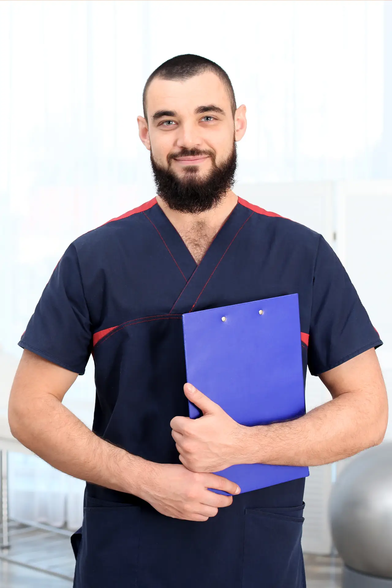 Male nurse holding care plan and clinical documentation in Sussex and Surrey