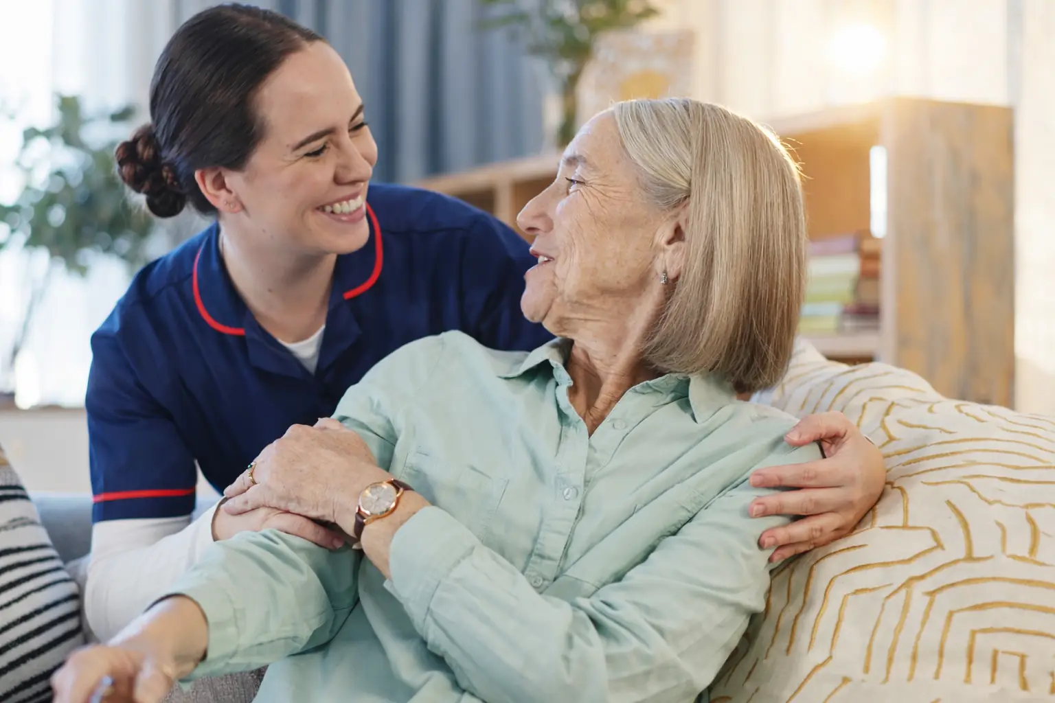 Nurse supporting elderly woman with personal care and companionship at home in Sussex and Surrey