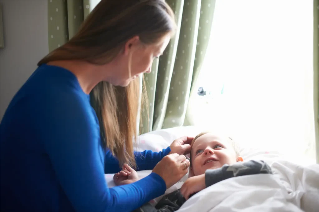 Parent providing gentle care and reassurance to a child at home